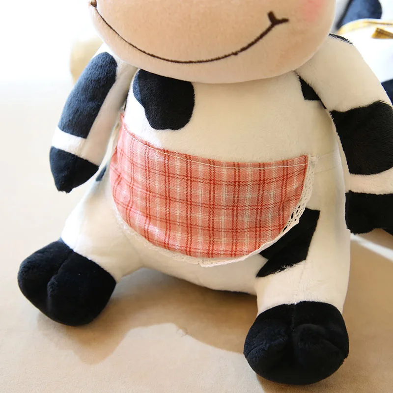 close up of the apron of cute cow stuffed animal toy