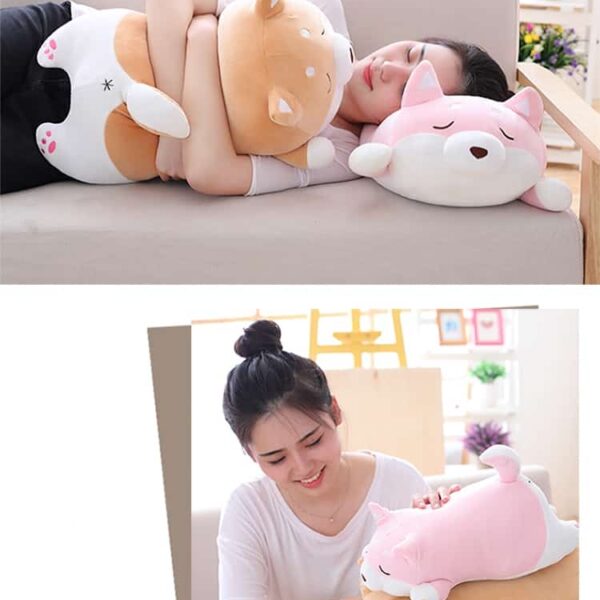 woman holding and sleeping on a cute fat shiba inu plush toy