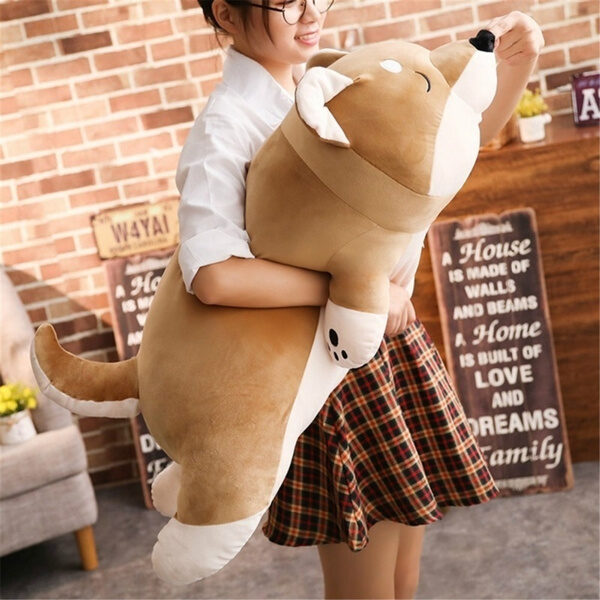 woman holding a giant shiba inu plush