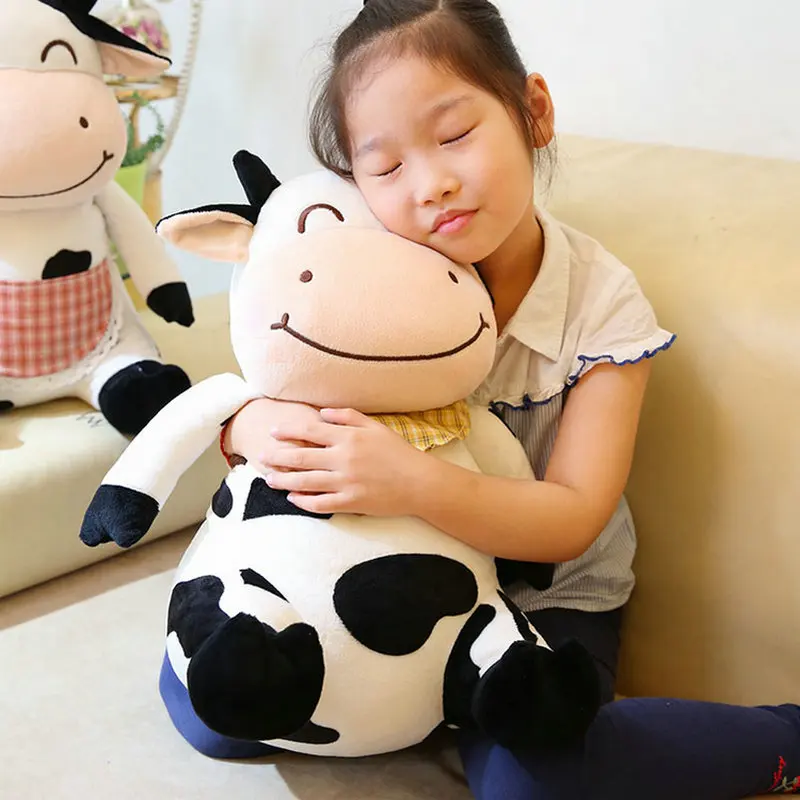 little girl hugging a cute cow stuffed animal toy