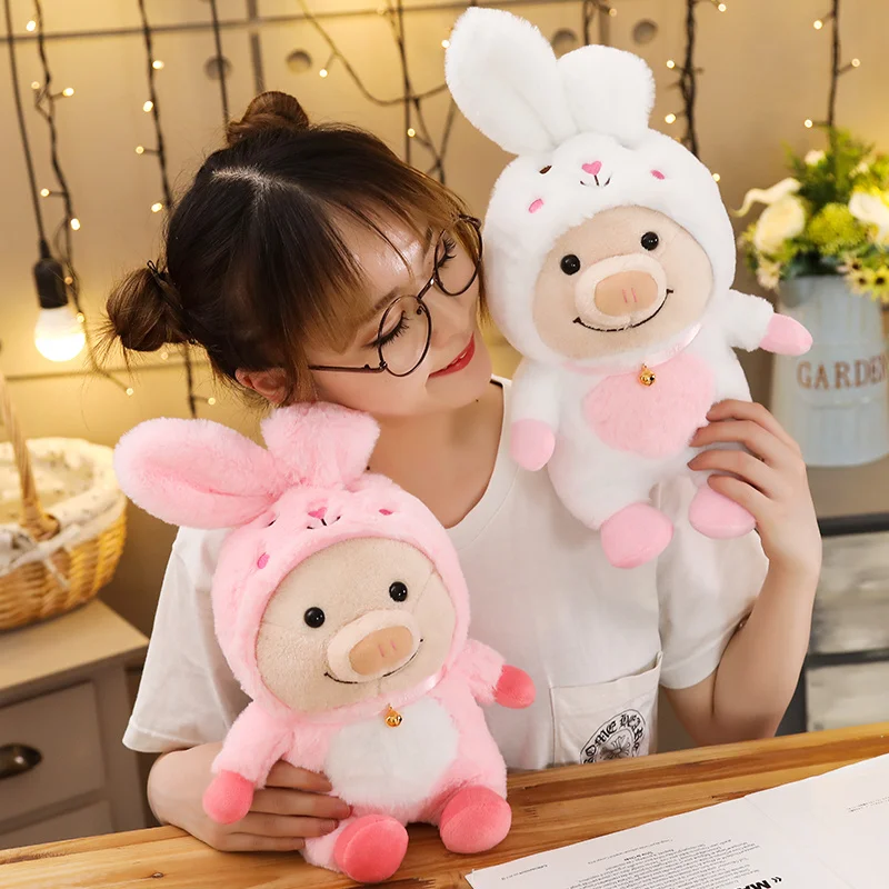 woman playing with white and pink rabbit cute pig plush