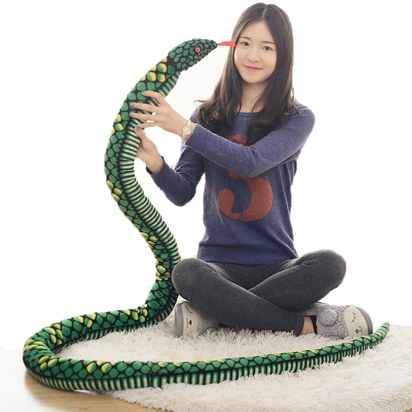 woman holding a green giant snake stuffed animal toy