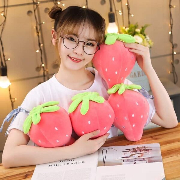 Cute Strawberry Plush Pillow Woman holding 4 cute pink strawberry plushies