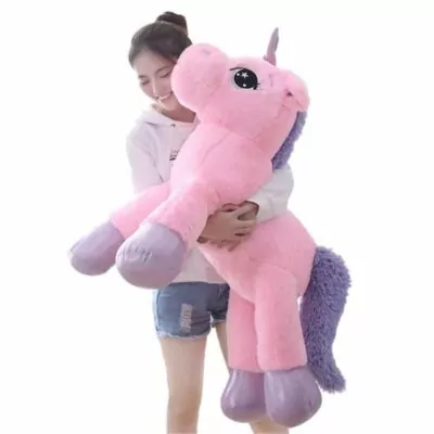 woman holding a giant unicorn plush