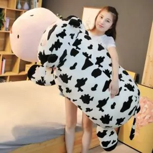 Woman Holding a Giant Cow Plush