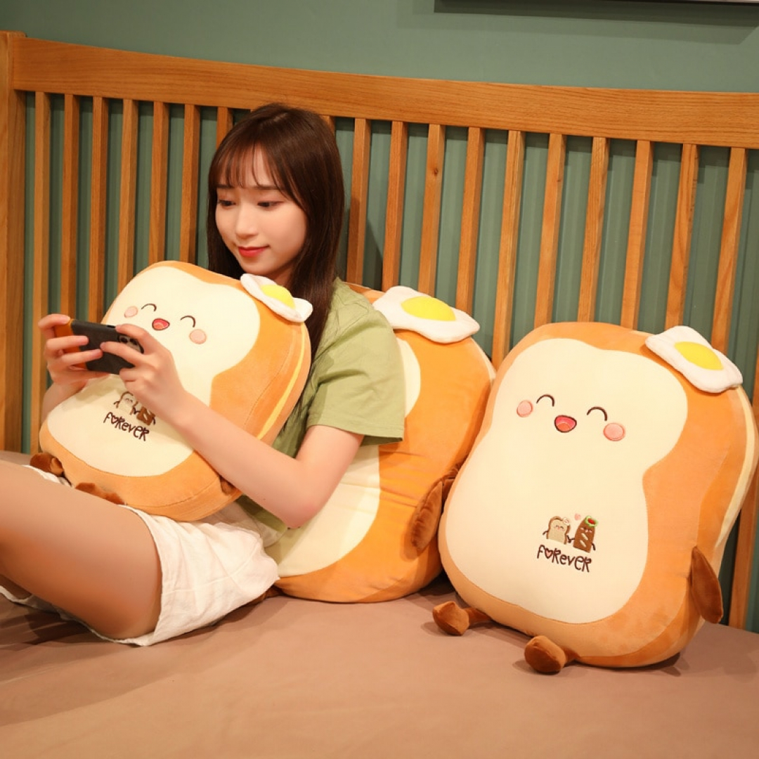 Woman holding a phone while sitting on a Kawaii Japanese Loaf Bread Plush