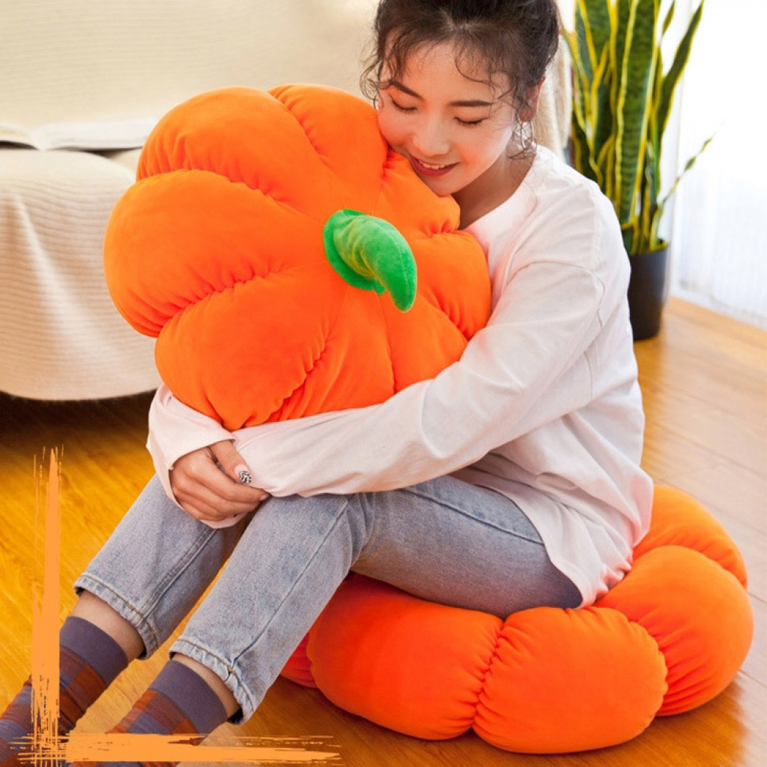 Woman sitting while hugging a Plush Pumpkin