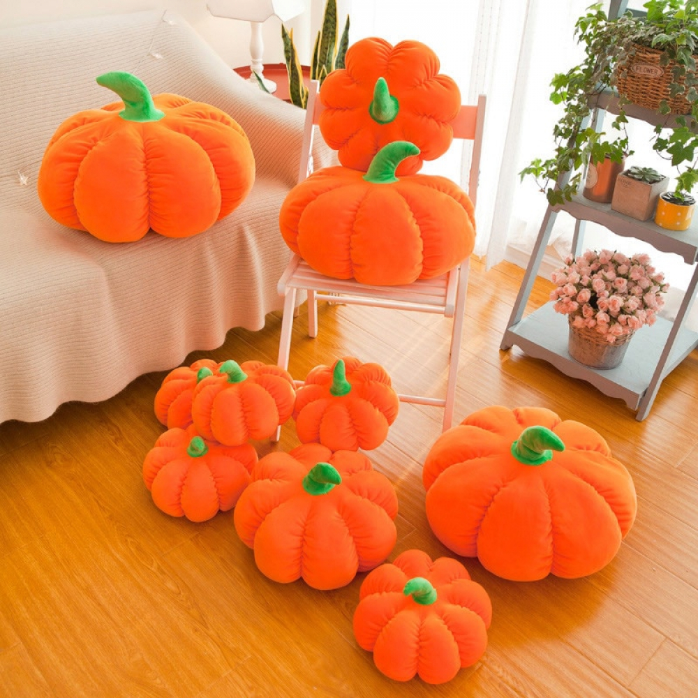 Multiple Plush Pumpkin in a bed room