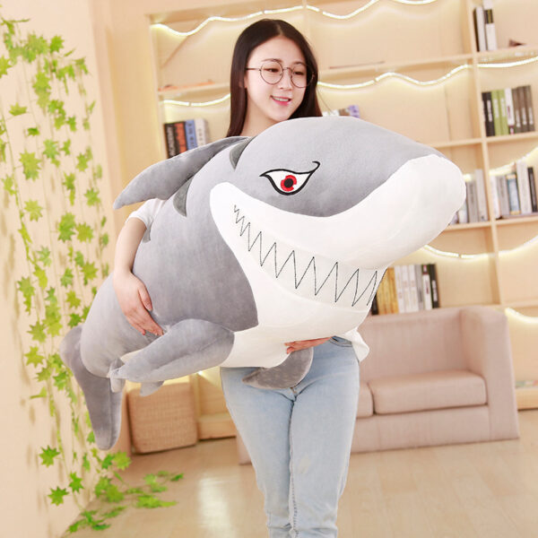 Giant Shark Plush Woman carrying a Giant Shark Plush