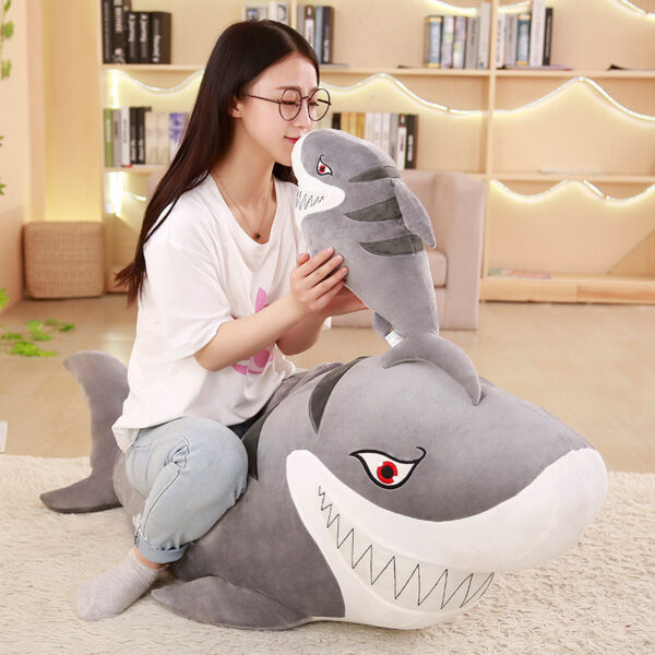 Giant Shark Plush Woman sitting on a Giant Shark Plush