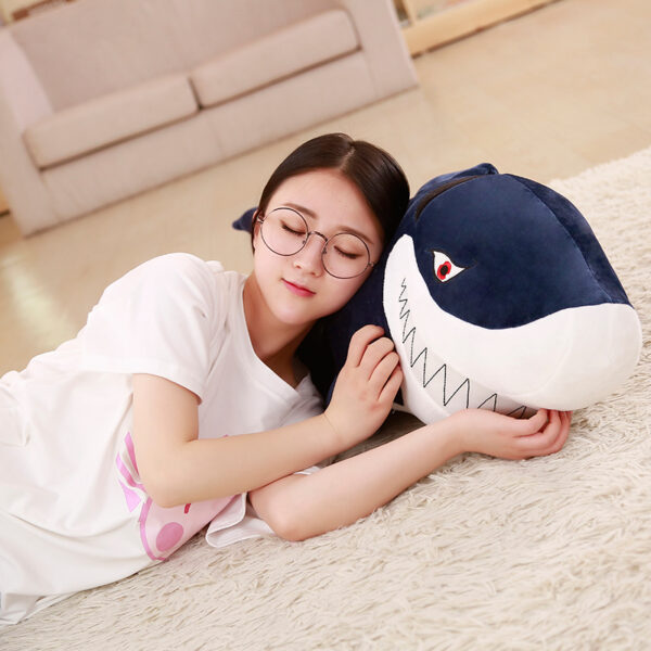 Giant Shark Plush Woman sleeping in a Giant Shark Plush