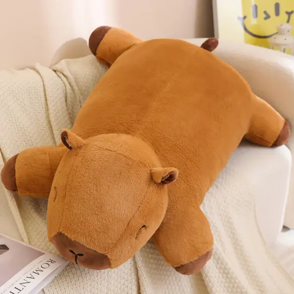 Giant Capybara Plush A large, soft giant capybara plush lying on a couch, showcasing its cozy and huggable design.