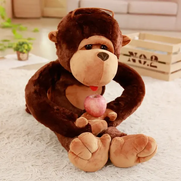 Kawaii Monkey Adorable monkey plush toy holding a red apple while sitting on a fluffy white rug.