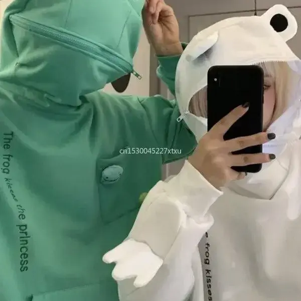 Frog Hoodie Woman wearing green frog hoodie with 3D eyes and zipped face